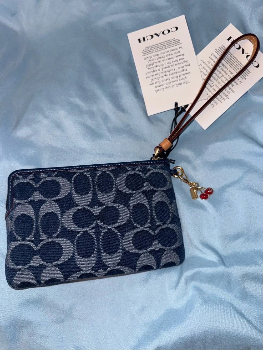 Coach Signature Denim Wristlet in Navy with Brown Leather Strap and cherry charm